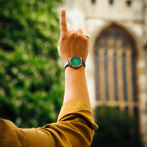 The wrist of a man wearing the Eden Green Beaucroft Senate watch at Senate House