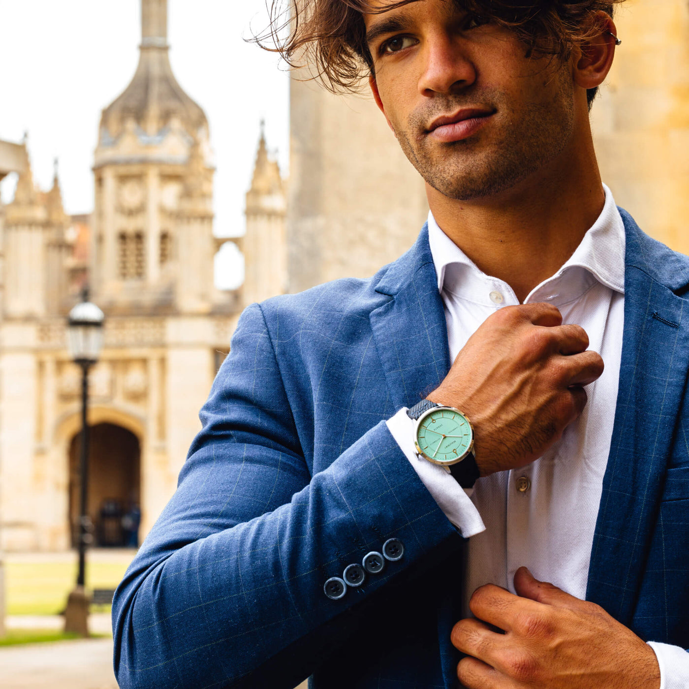 Man wearing a Beaucroft Cambridge Blue watch outside Kings College Cambridge
